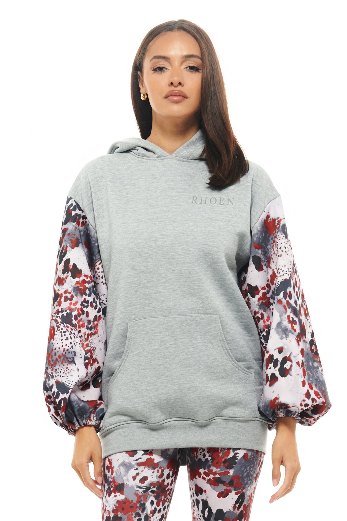 RHOEN grey hoodie with bespoke Rebecca Rhoades abstract print balloon sleeves in red, black, and grey tones.