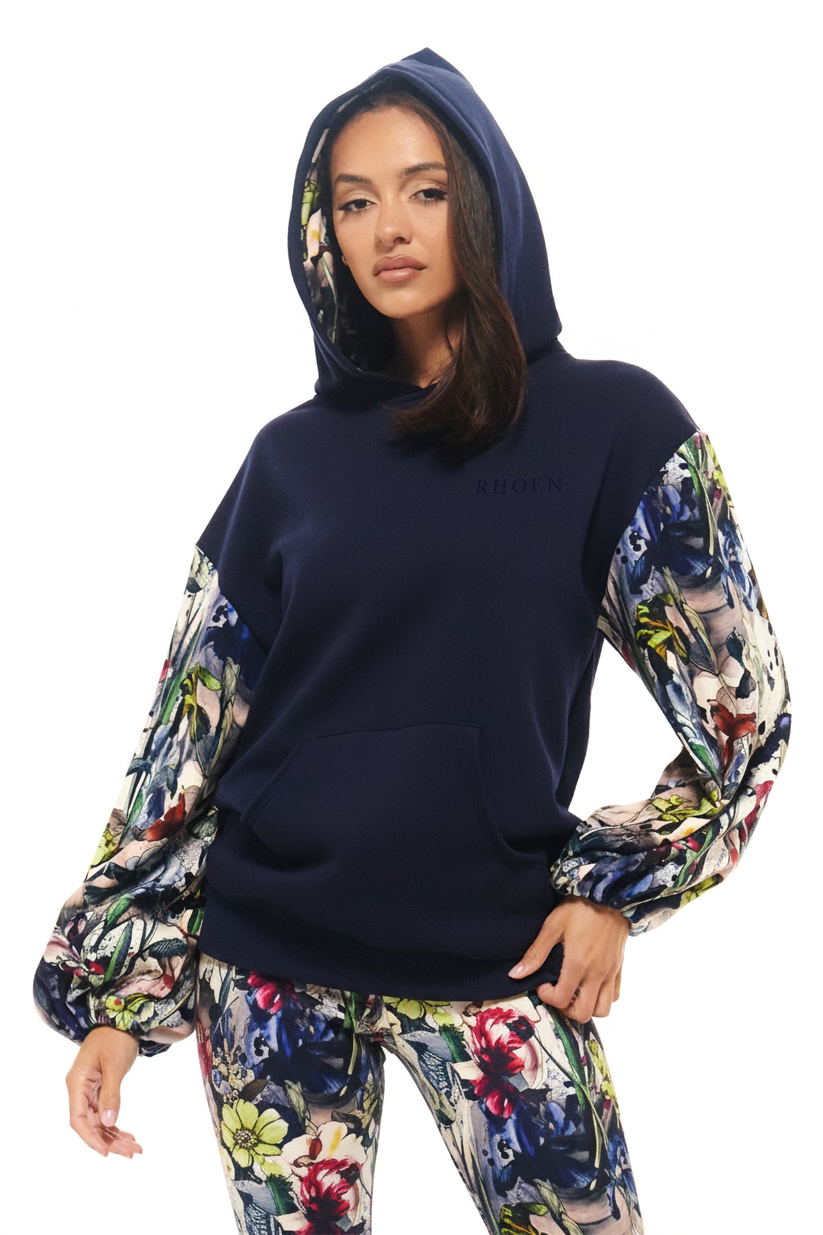 RHOEN fashion hoodie in navy jersey with vibrant floral-illustrated print sleeves, part of Rebecca Rhoades’ exclusive collection.