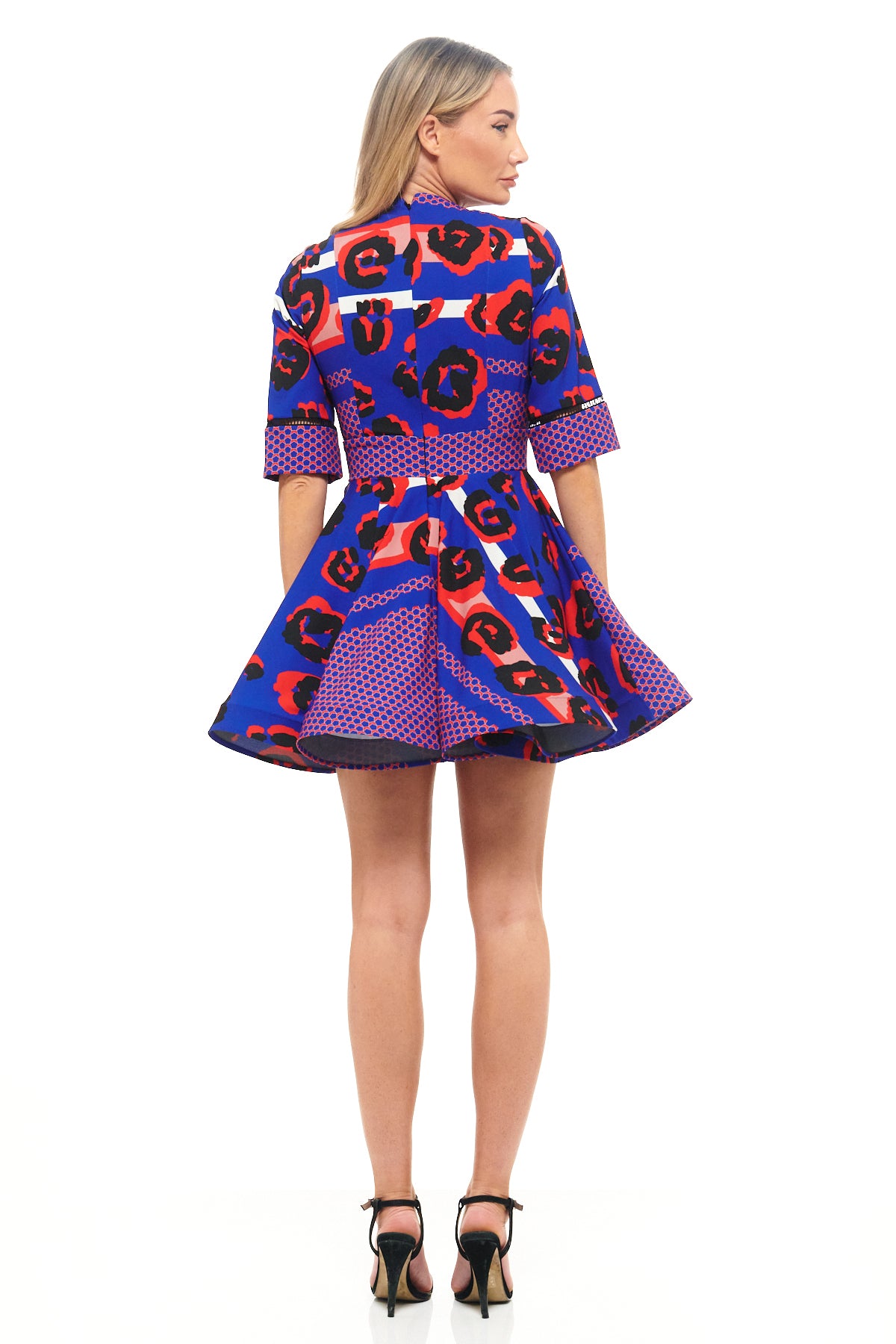 Bold blue leopard print cocktail dress by RHOEN (formerly Rebecca Rhoades) – mini length with fitted waist, flared hemline, and modern high neckline.
