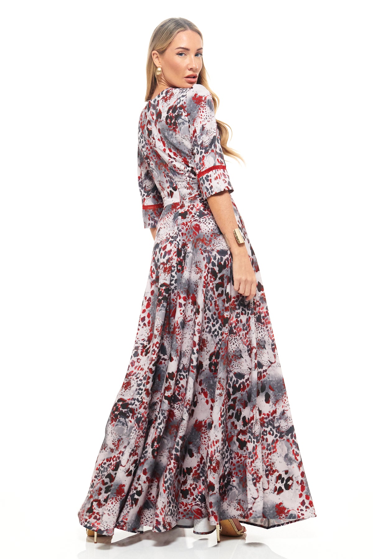 Luxury maxi dress by RHOEN featuring bold red, grey, and black animal-inspired print, deep neckline, and elegant side leg split.