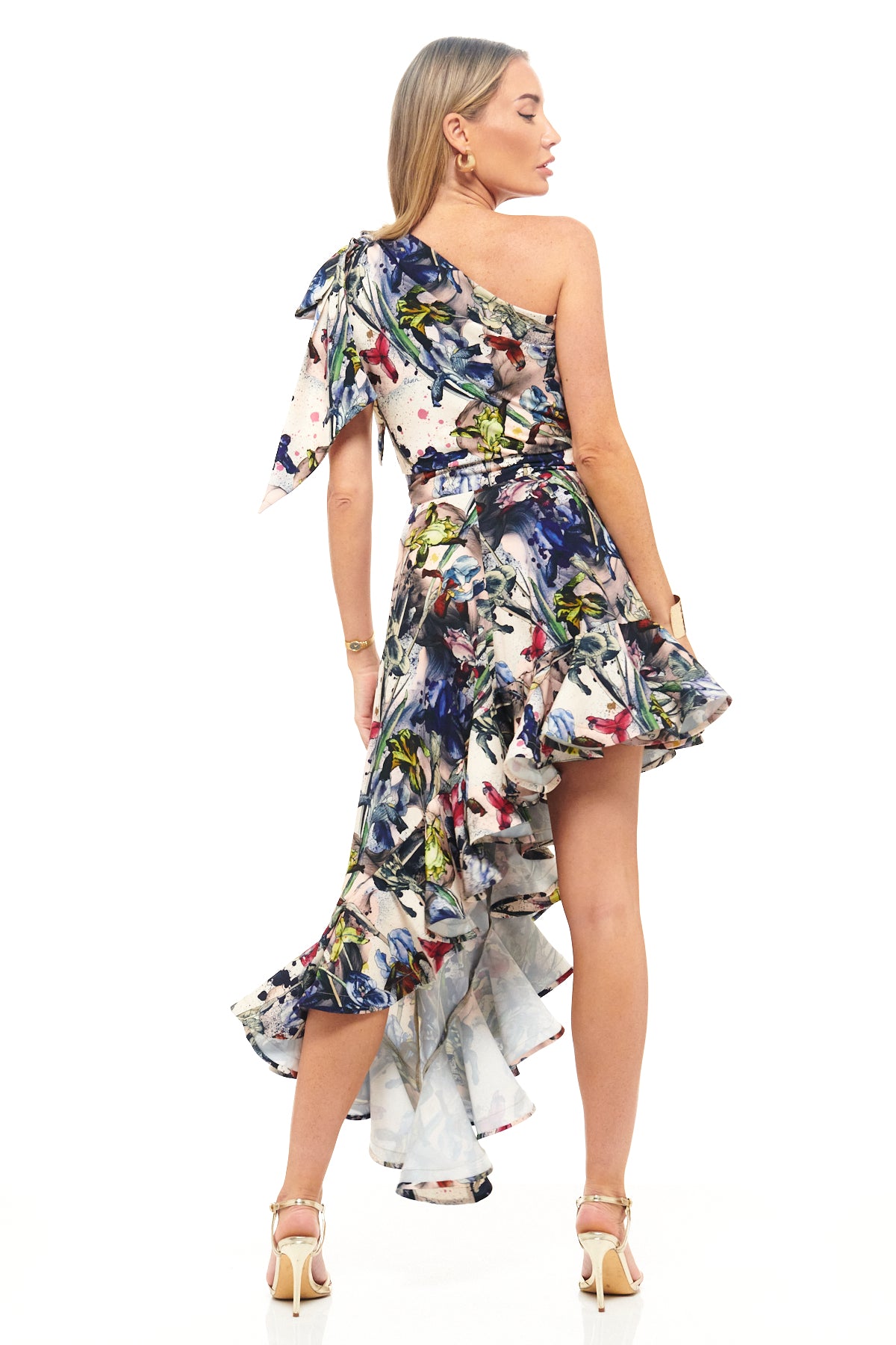 Designer statement dress by RHOEN in exclusive floral print, crafted with a one-shoulder neckline and high-low ruffled hemline for weddings and luxury events.