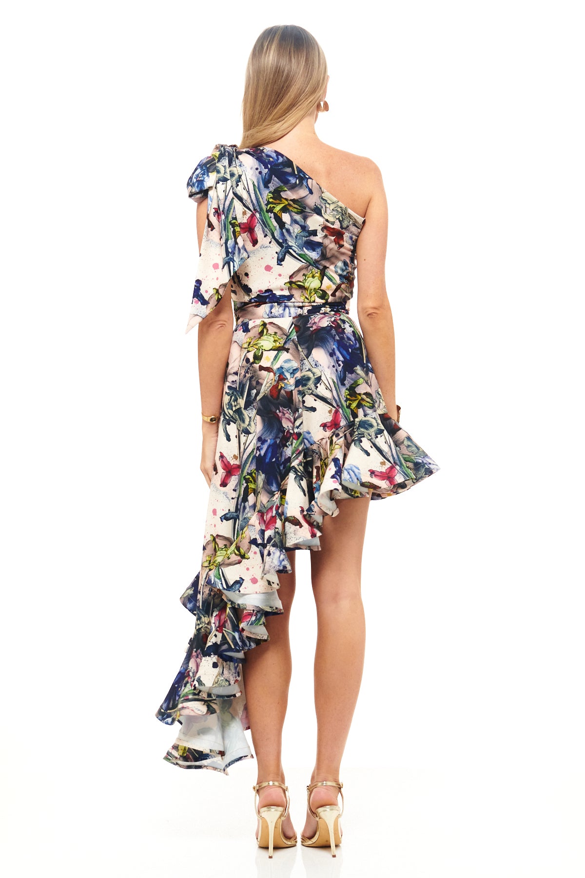 Designer statement dress by RHOEN in exclusive floral print, crafted with a one-shoulder neckline and high-low ruffled hemline for weddings and luxury events.