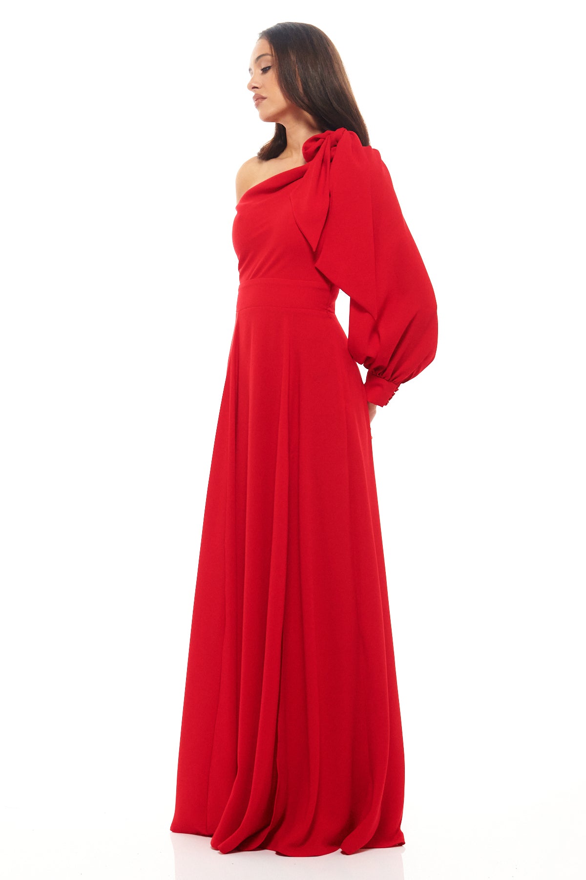 Rhoen asymmetric red gown with elegant single sleeve, defined waistband and side split, perfect for modern glamour.