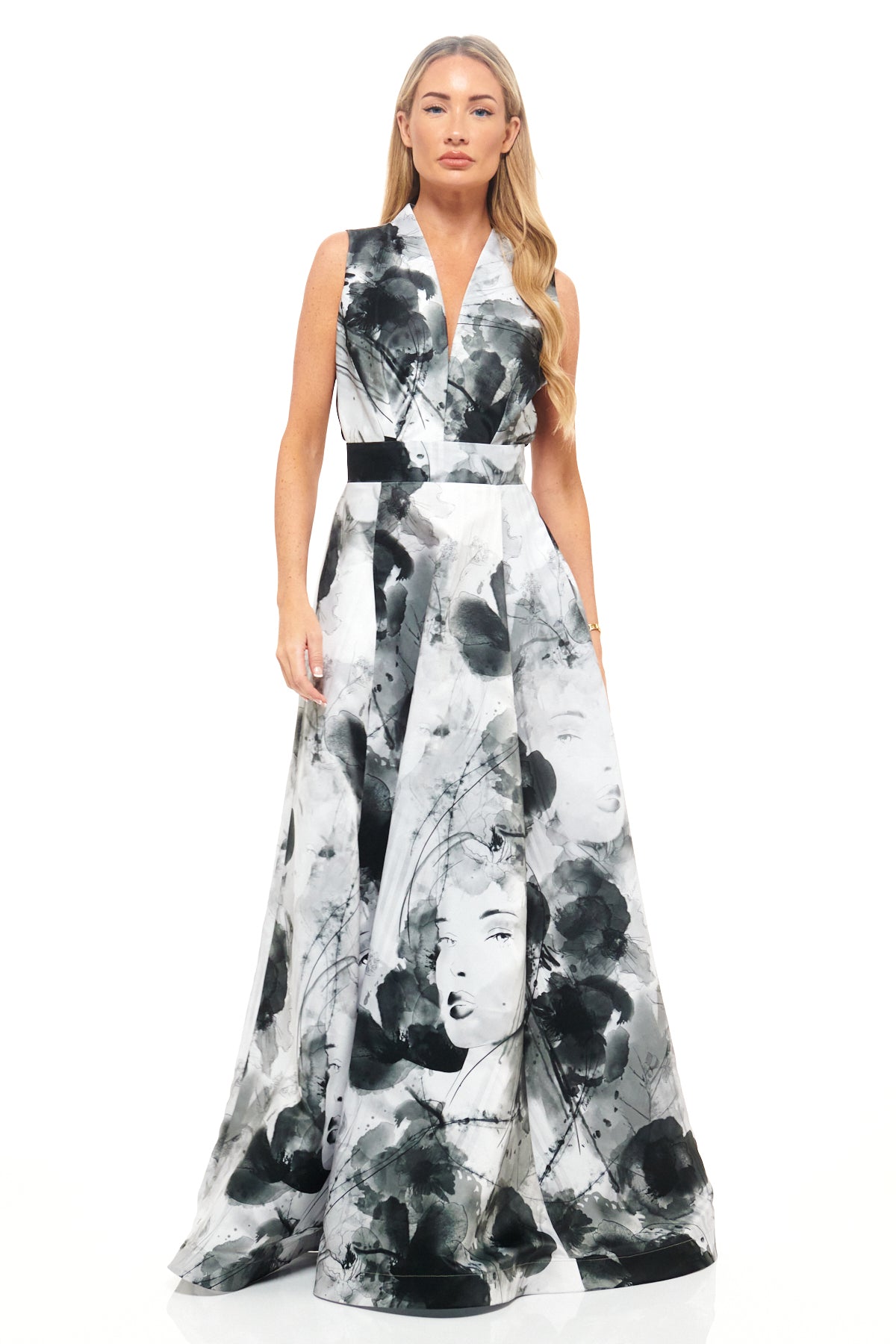 RHOEN monochrome maxi dress by Rebecca Rhoades featuring a deep V-neckline, fitted waistband, and full skirt with bold illustrated face and floral print.