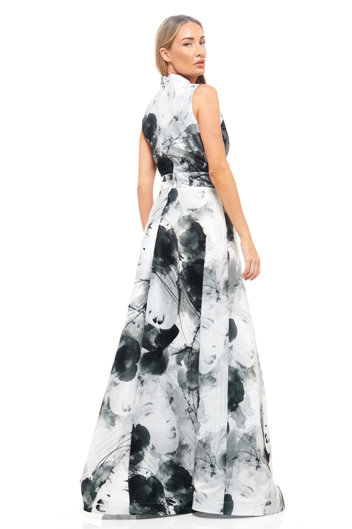 Black and white statement gown from RHOEN, designed by Rebecca Rhoades, with a plunging neckline and artistic face-and-floral bespoke print.
