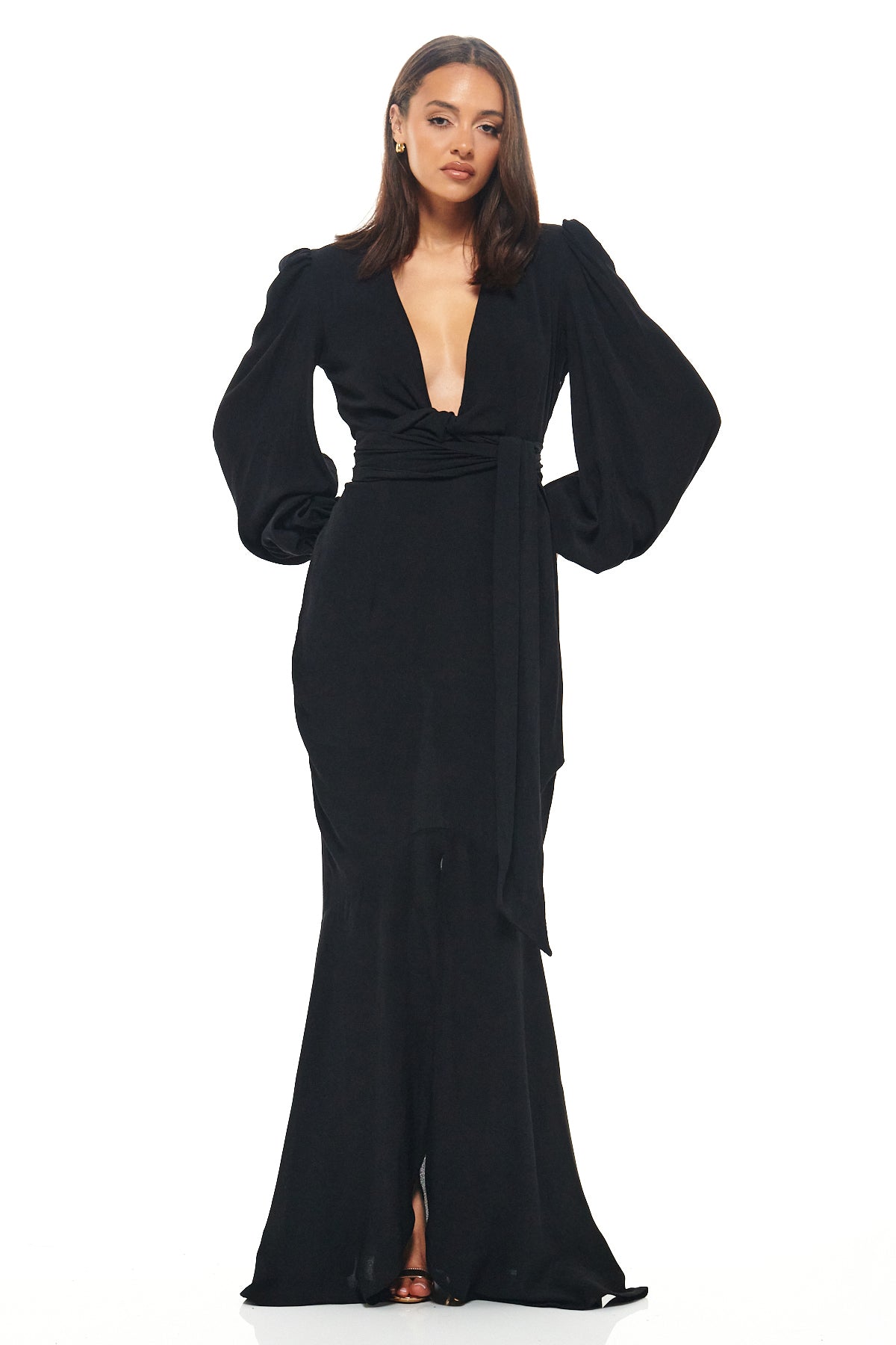 Sophisticated black evening gown by Rhoen featuring a plunging neckline, long sleeves, draped waist tie and dramatic fishtail skirt.