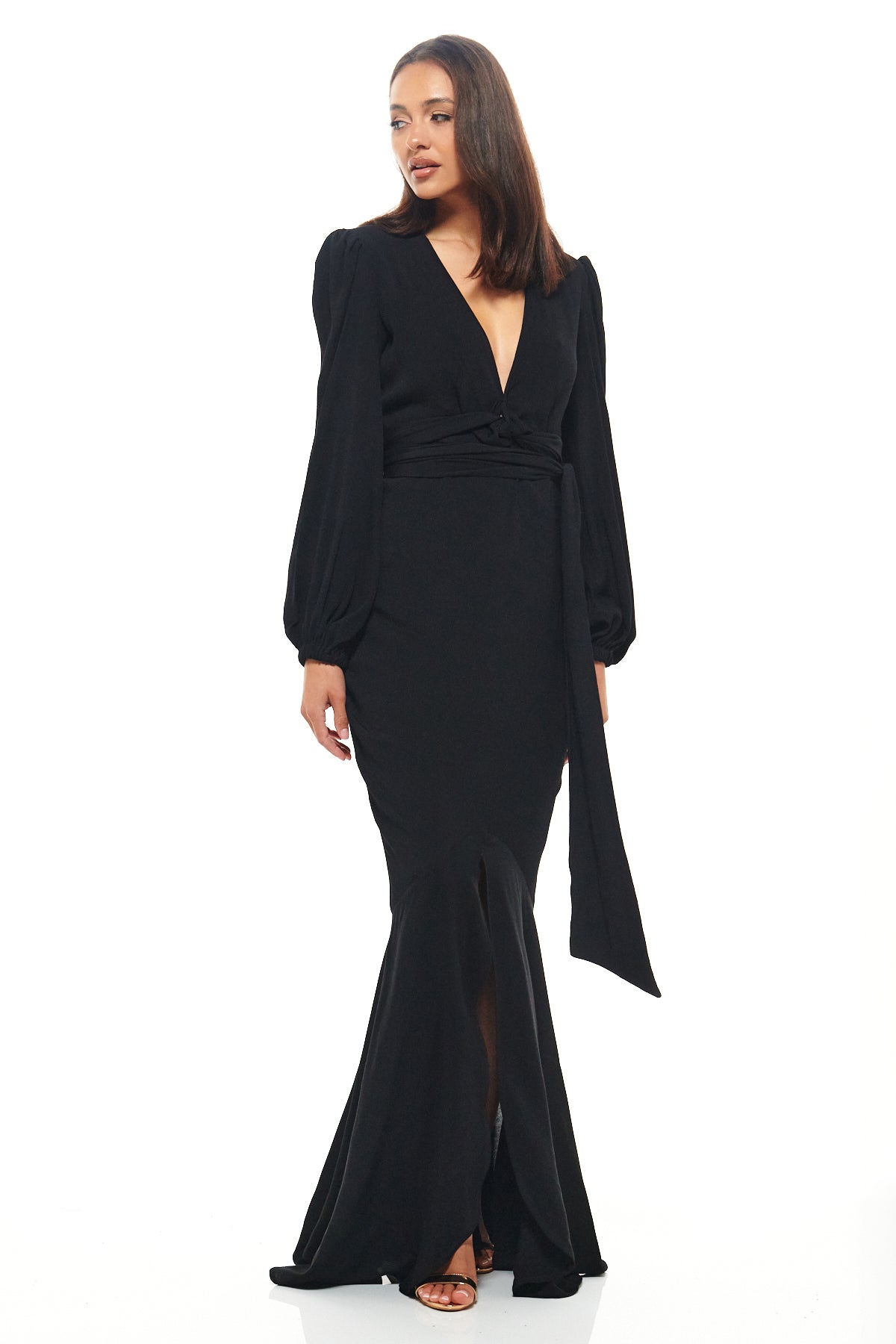 Elegant black Rhoen gown with long sleeves, belted waist and floor-sweeping fishtail hem, echoing the drama once seen in Rebecca Rhoades statement dresses.
