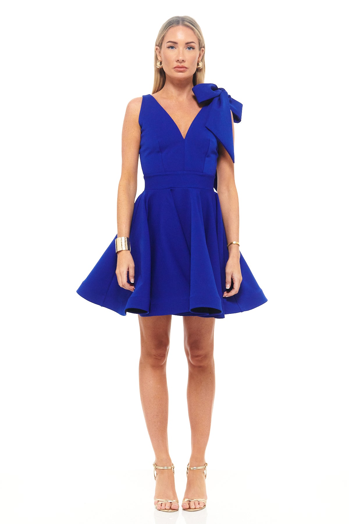 Rhoen cobalt blue mini dress with fit-and-flare silhouette, deep V-neckline and statement bow detail on one shoulder for playful evening elegance.