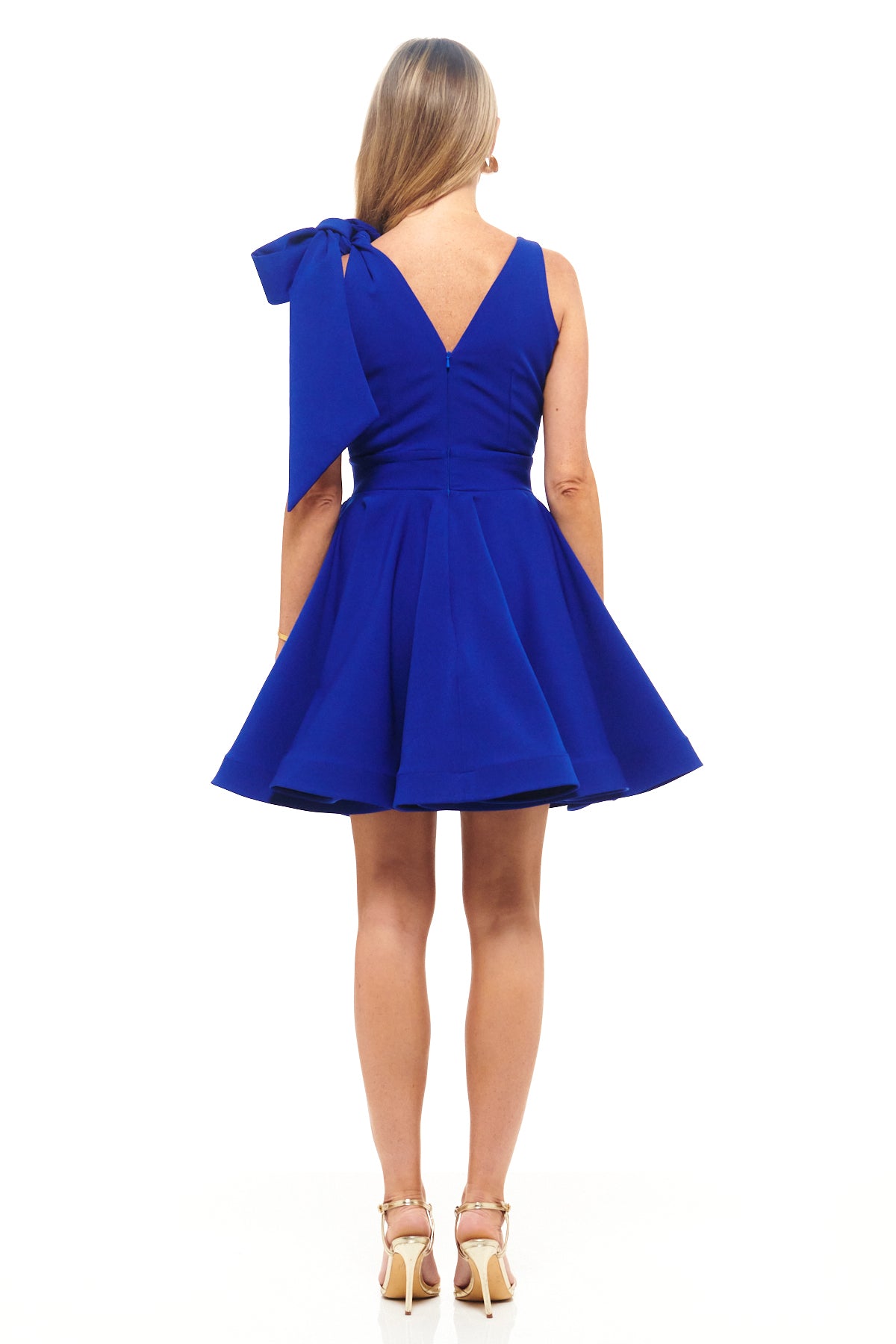 Structured cobalt mini dress by Rhoen with flirty flared hem, deep V-neckline and signature one-shoulder bow detail.