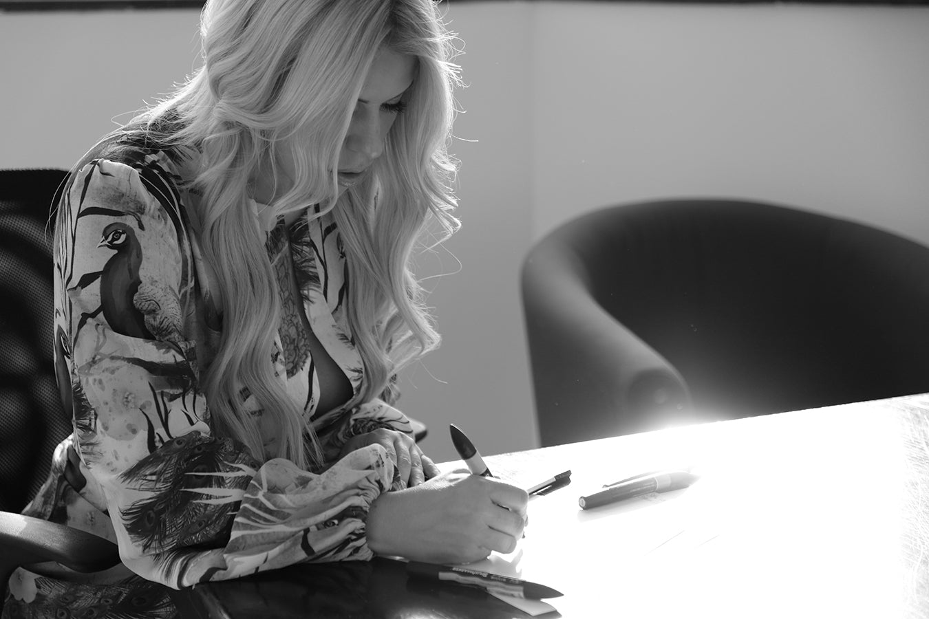 Rebecca drawing bespoke design wearing a Rhoen maxi dress in Peacock Print. Rebecca designs and produces her garments in the UK.
