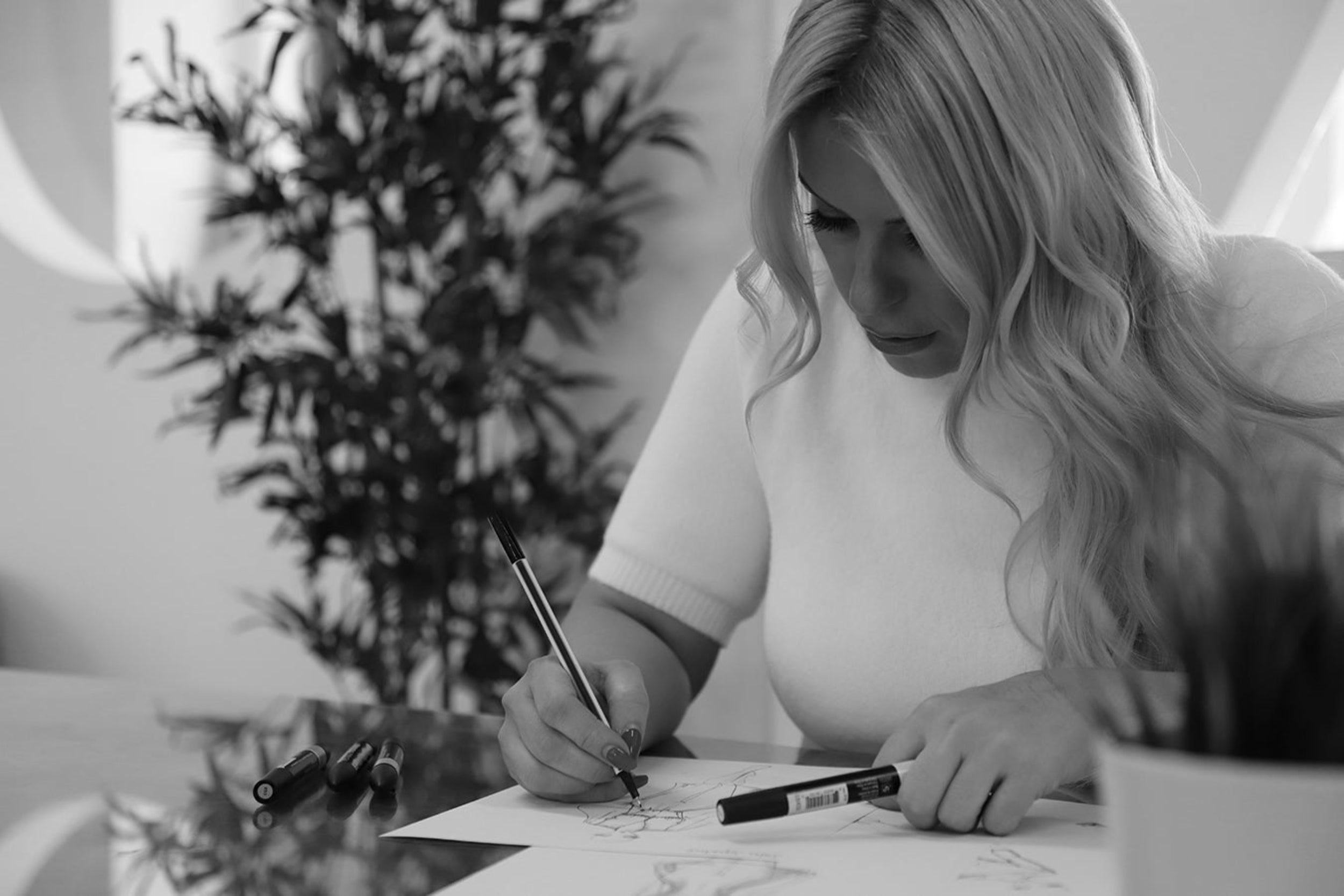Rebecca Rhoades Drawing her original designs by hand sketch. Every design is started in this way to create bespoke one of a kind garments.