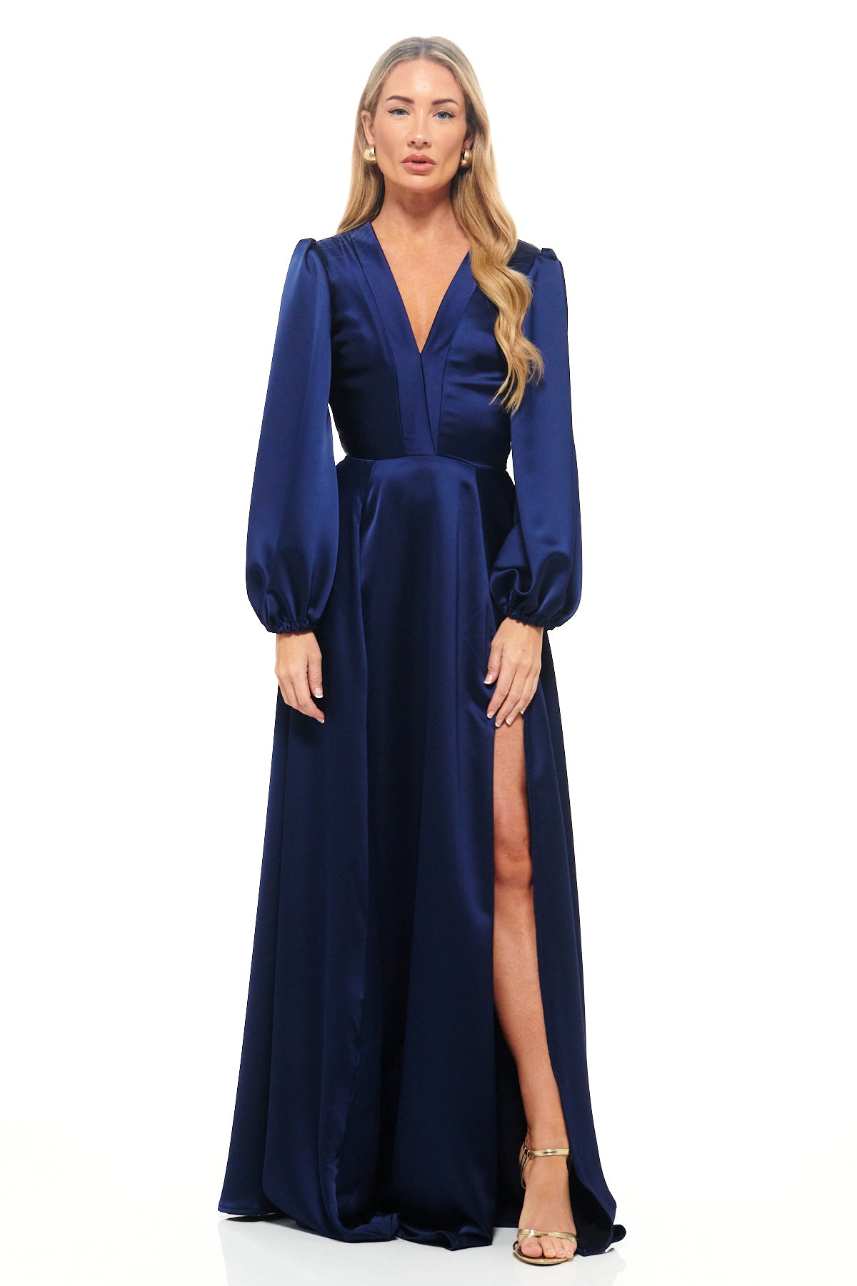 RHOEN navy satin evening gown – luxury long dress with deep V-neckline, full-length sleeves, and thigh-high slit. Designed by Rebecca Rhoades.