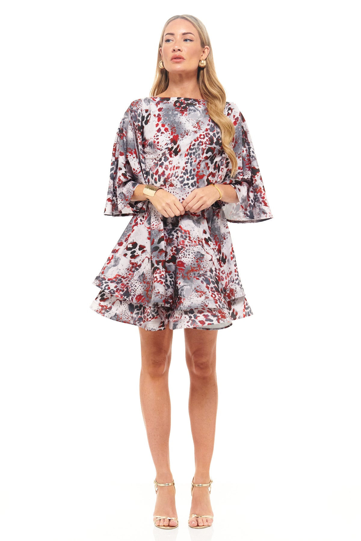 Luxury RHOEN mini dress in bold red, black, and grey leopard-inspired print, featuring dramatic wide sleeves and playful flared hemline.