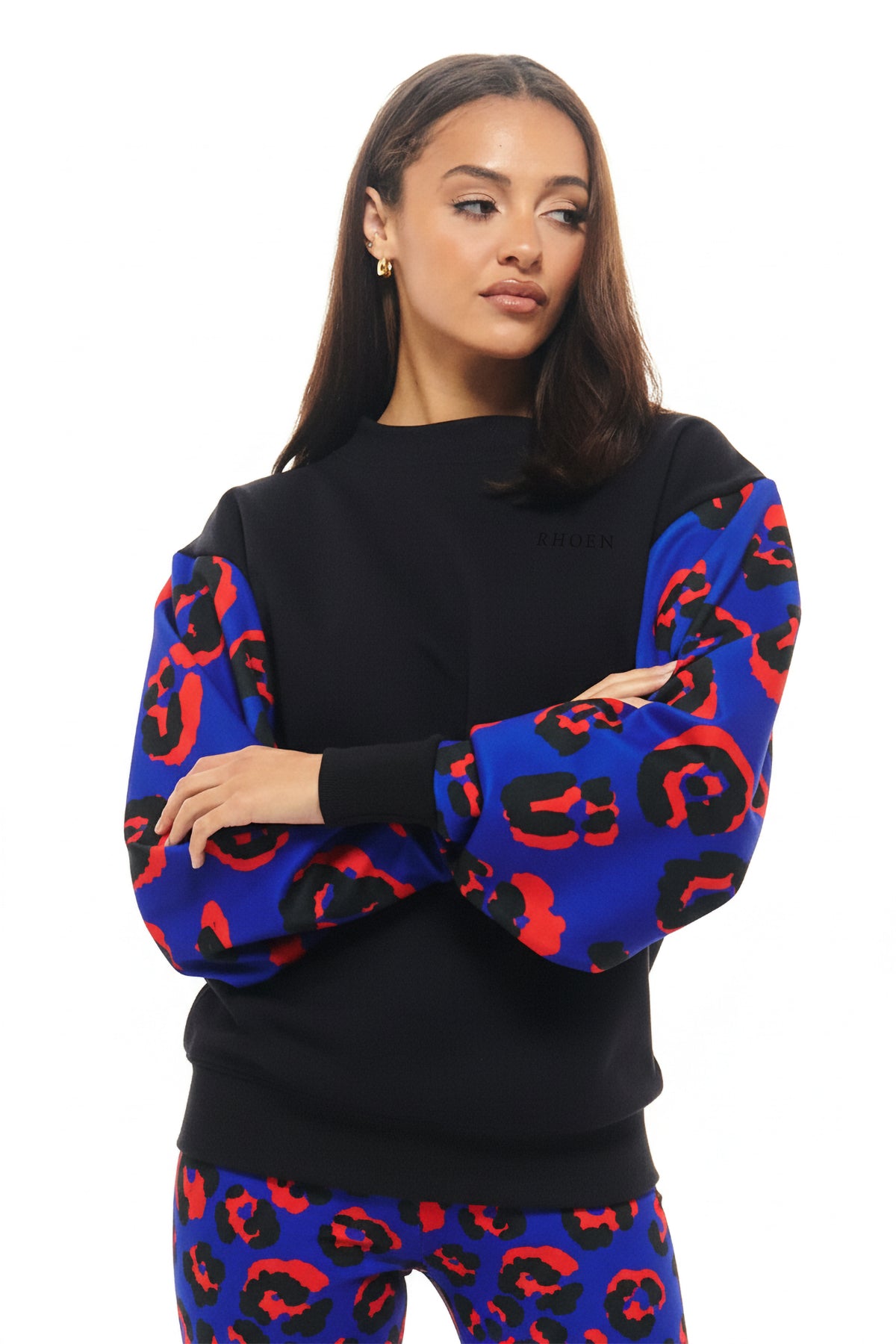Relaxed black crewneck by RHOEN featuring statement sleeves in bold cobalt blue and red leopard design.
