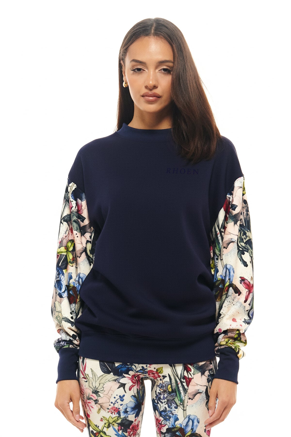 Navy RHOEN sweatshirt with statement sleeves in the exclusive botanical print, styled with matching leggings.