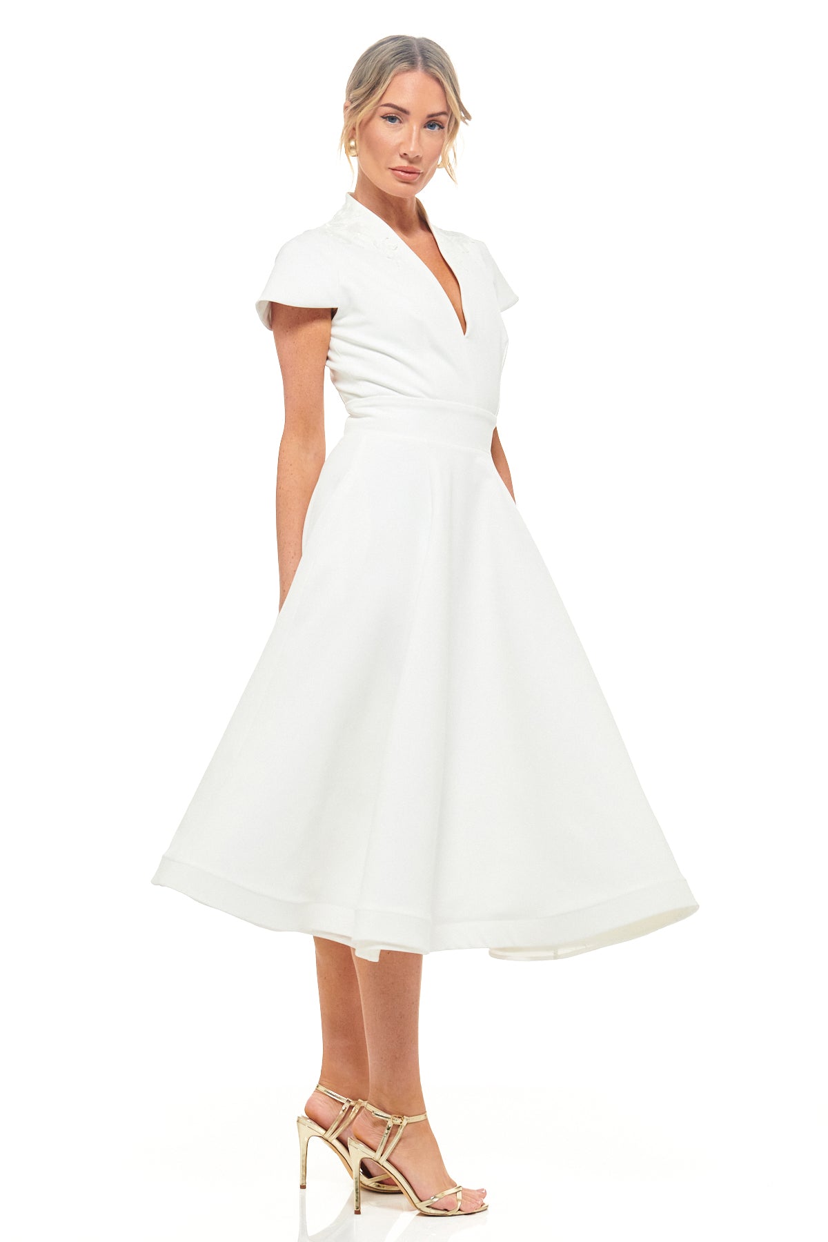 Elegant ivory midi dress by RHOEN with short cap sleeves, fitted waist, and flared skirt. A sophisticated bridal-inspired style ideal for rehearsal dinners, modern weddings, and special occasions.