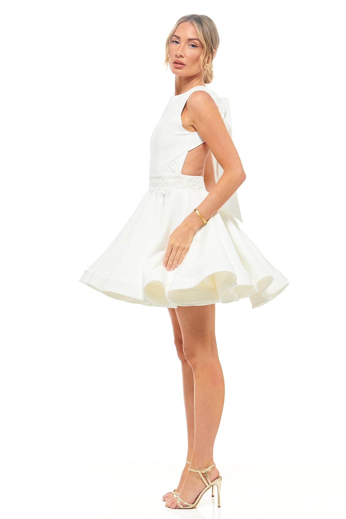 RHOEN ivory mini bridal dress – sleeveless high-neck short gown with cut-out sides, voluminous skirt, and elegant bow back feature.