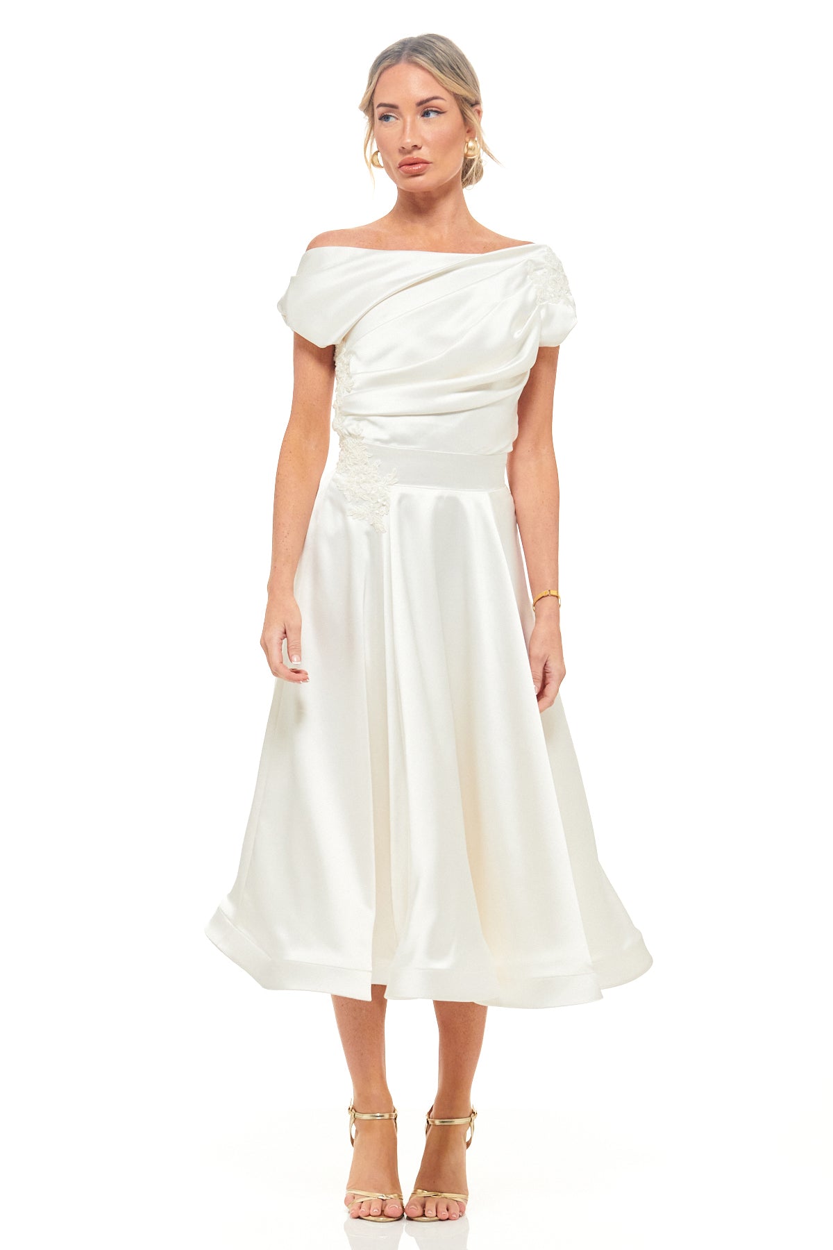 RHOEN ivory satin midi dress by Rebecca Rhoades, featuring an off-the-shoulder draped bodice with floral applique and a flowing A-line skirt – timeless bridal or evening style.