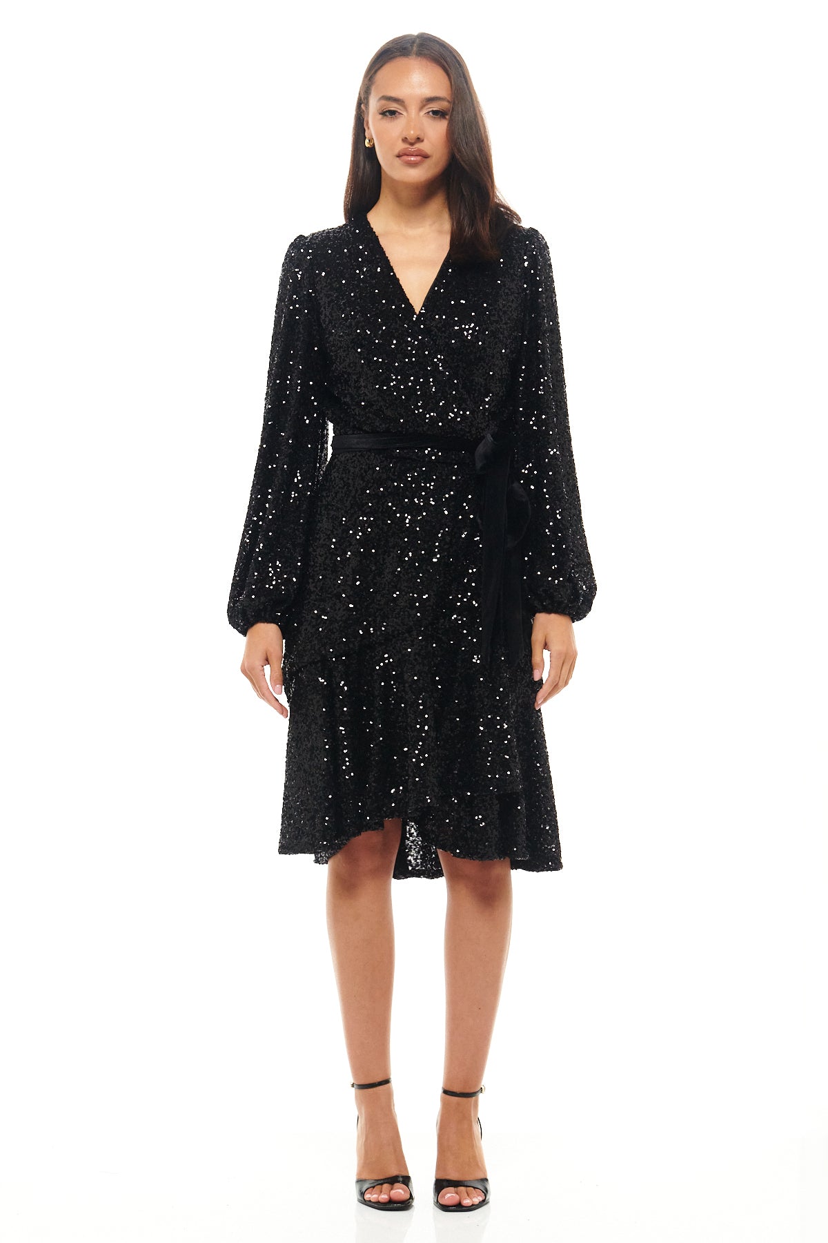 Rhoen black sequin wrap dress with long sleeves, V-neckline and soft waist tie, shimmering with classic elegance – a modern evolution of the iconic Rebecca Rhoades sequin look.