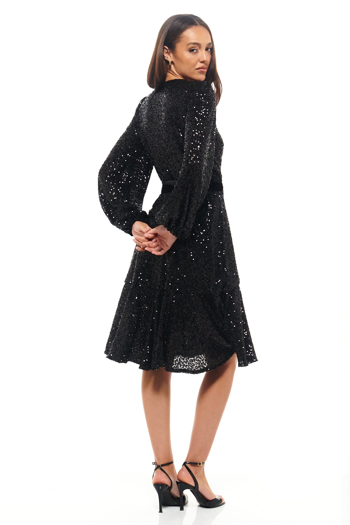 Elegant long-sleeved black sequin wrap dress by Rhoen, a reimagined classic with flattering draping and sparkling finish, continuing the Rebecca Rhoades sequin heritage.