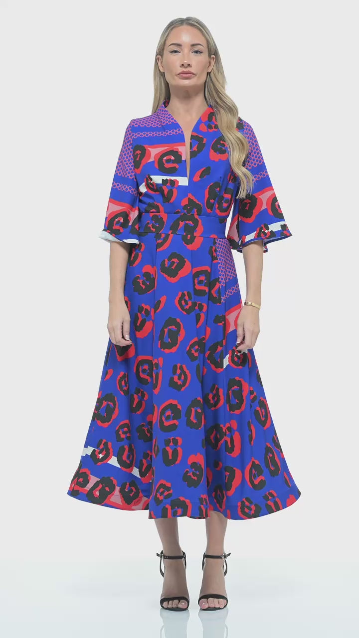 RHOEN bespoke leopard print midi dress in vivid blue and red, designed by Rebecca Rhoades. Features a plunging V-neckline, three-quarter sleeves, and a flowing A-line skirt for modern occasionwear