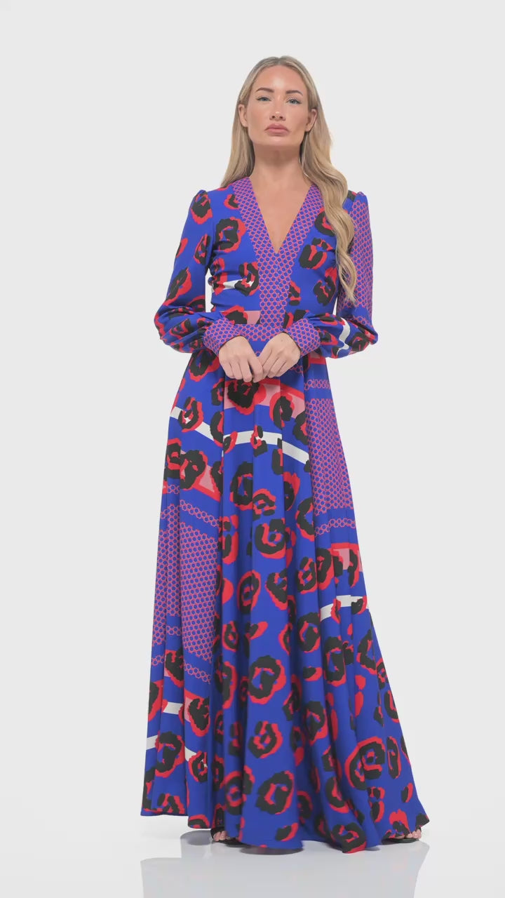 RHOEN bold print long sleeve maxi dress – dramatic designer gown with vivid red and blue leopard pattern, deep V-neckline, and sweeping silhouette.