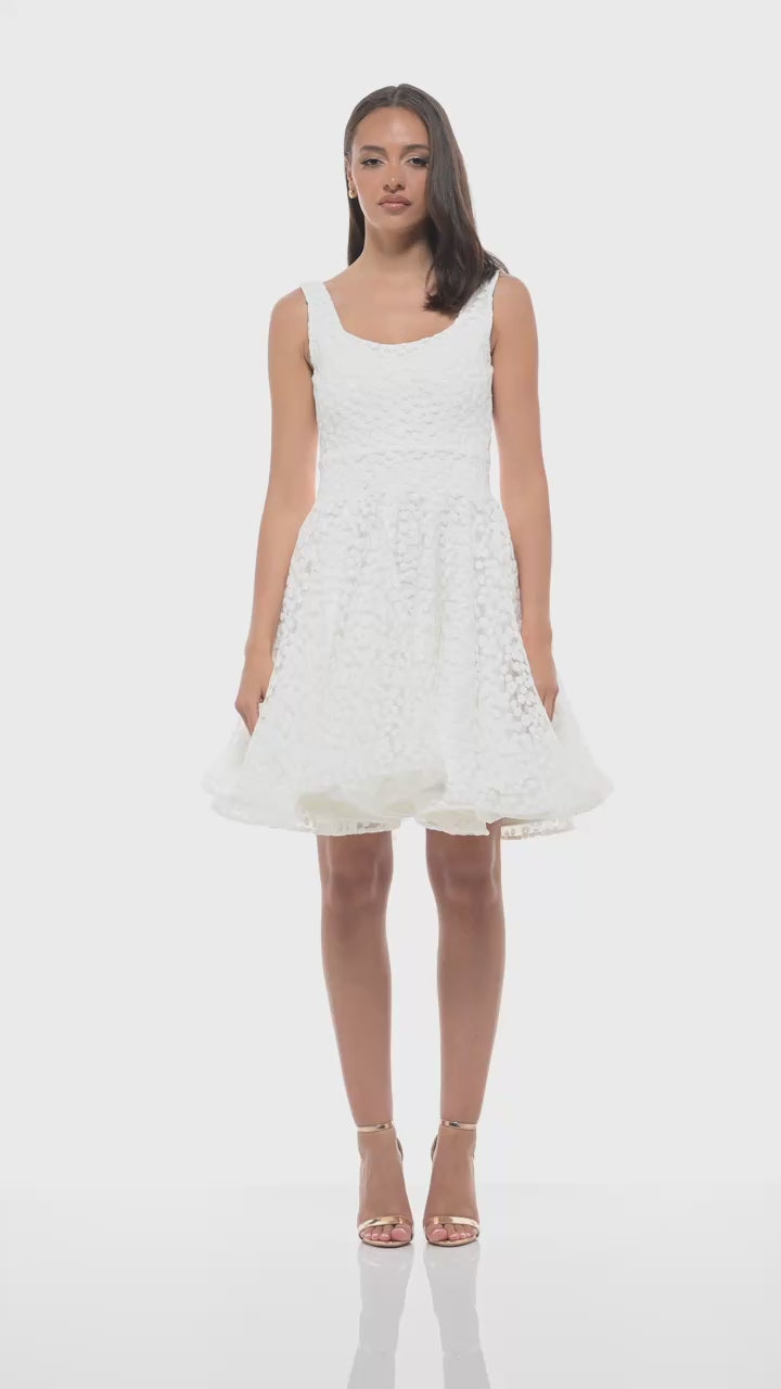 RHOEN ivory bridal mini dress crafted in a delicate textured fabric with scoop neckline and voluminous skirt. Ideal as a rehearsal dinner dress, wedding reception change, or contemporary bridal look.