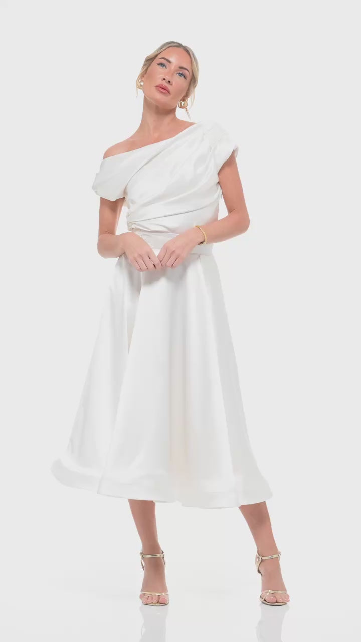 Designer ivory satin dress from RHOEN, with one-shoulder draped detailing, floral applique, and a feminine flared midi skirt – ideal for modern brides or elegant eveningwear.