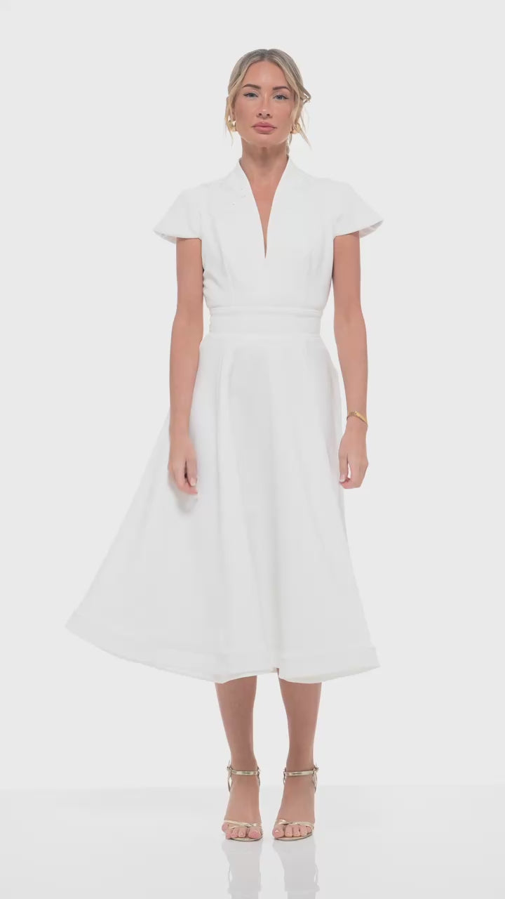 RHOEN ivory bridal midi dress with cap sleeves and tailored waistline, flowing into a structured skirt. Perfect for brides seeking a refined look for receptions, bridal showers, or post-ceremony celebrations.
