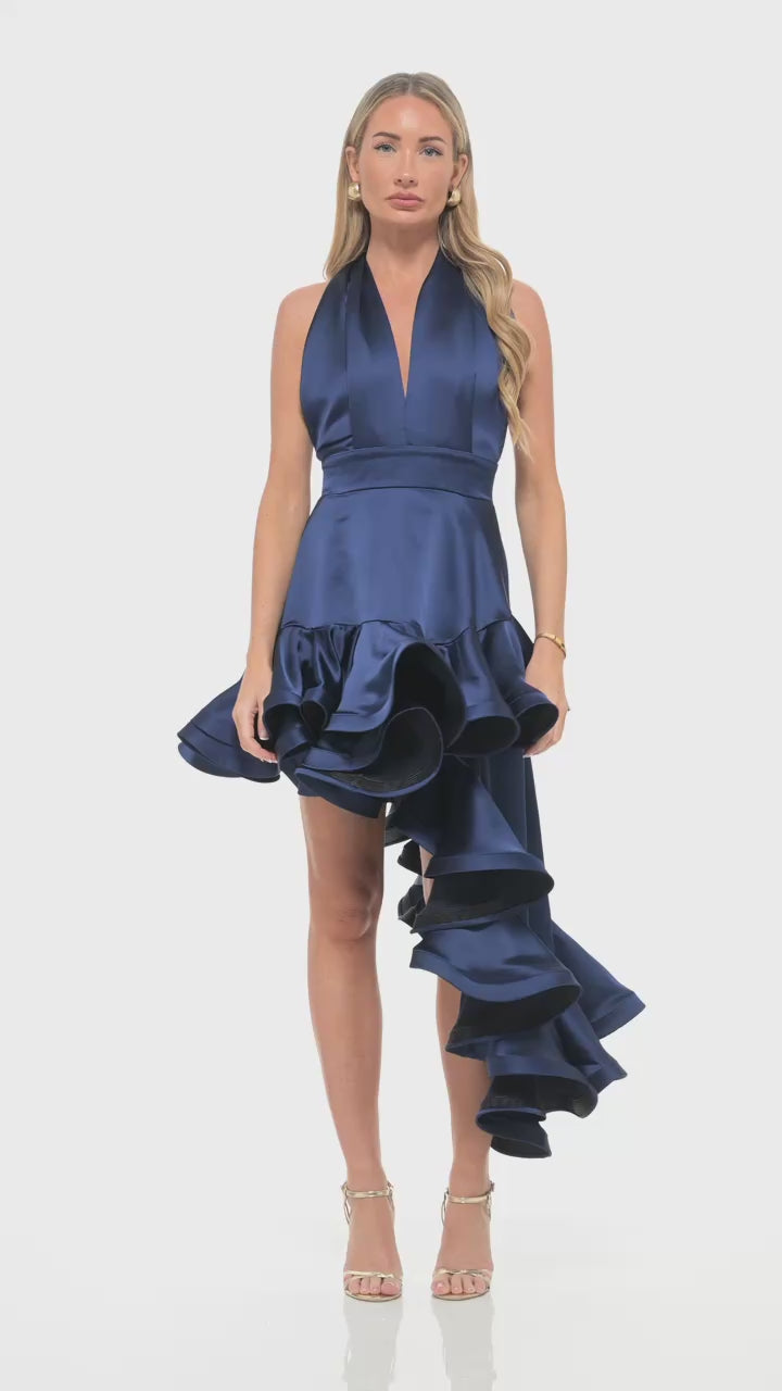 RHOEN navy blue satin high-low ruffle dress by Rebecca Rhoades featuring a plunging halter neckline, fitted waist, and dramatic asymmetric layered skirt – luxury eveningwear statement piece.