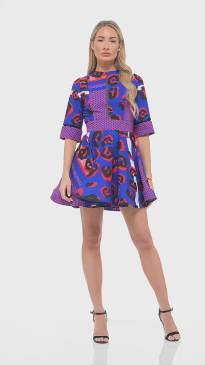 RHOEN blue and red print mini dress – luxury designer skater-style dress with half sleeves, bespoke leopard print artwork, and flattering structured cut.